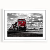 Abstract art print of a stylized train in muted gray and blue tones on a white framed poster.