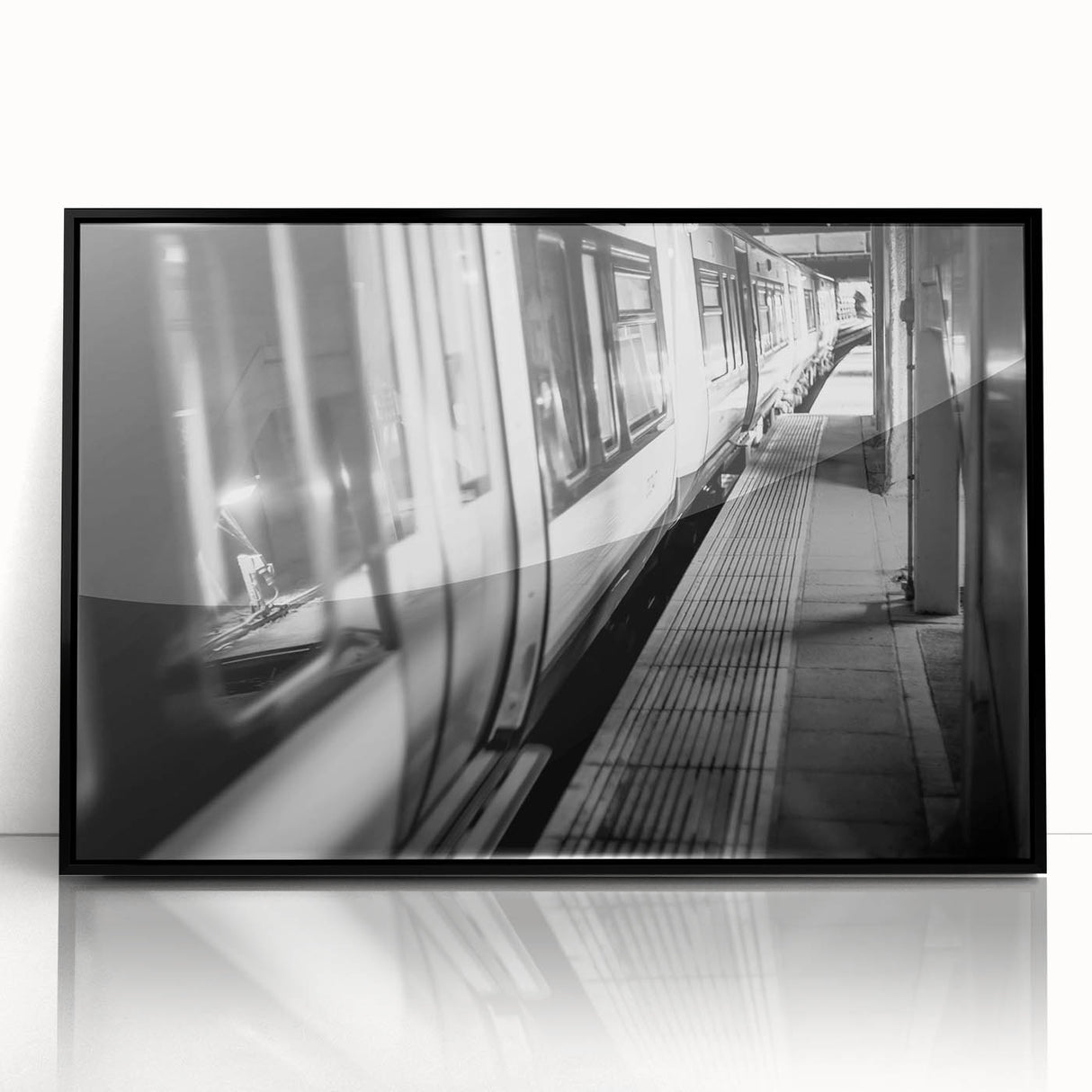 Large abstract wall art featuring a stylized train in muted gray and blue tones on a black framed acrylic.