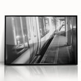 Large abstract wall art featuring a stylized train in muted gray and blue tones on a black framed acrylic.