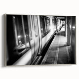 Framed canvas featuring a vintage poster of a colorful train in a black landscape, ideal for a modern living room.