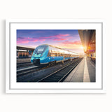 Abstract art print of a stylized train in muted gray and blue tones, framed with a white mat.