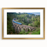 Extra large abstract art print of a train, in gold frame with mat, featuring textured gray and blue tones.