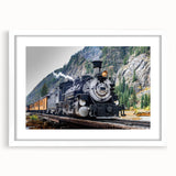 Abstract art print of a stylized train in muted blue and gray tones on a white framed poster, suitable for dining room decor.