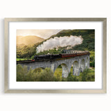 Textured art print of an abstract train in muted gray and blue tones, framed in silver, ideal for bedroom wall decor.