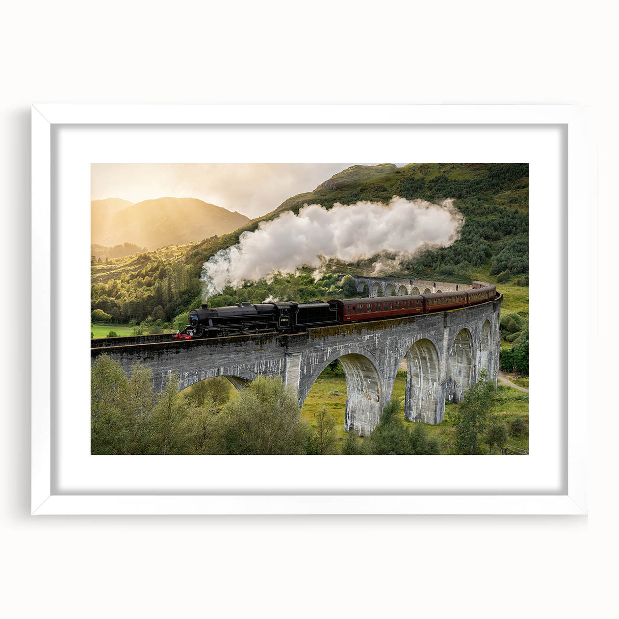 Abstract art print of a stylized train in vibrant blues and oranges on a white framed poster.