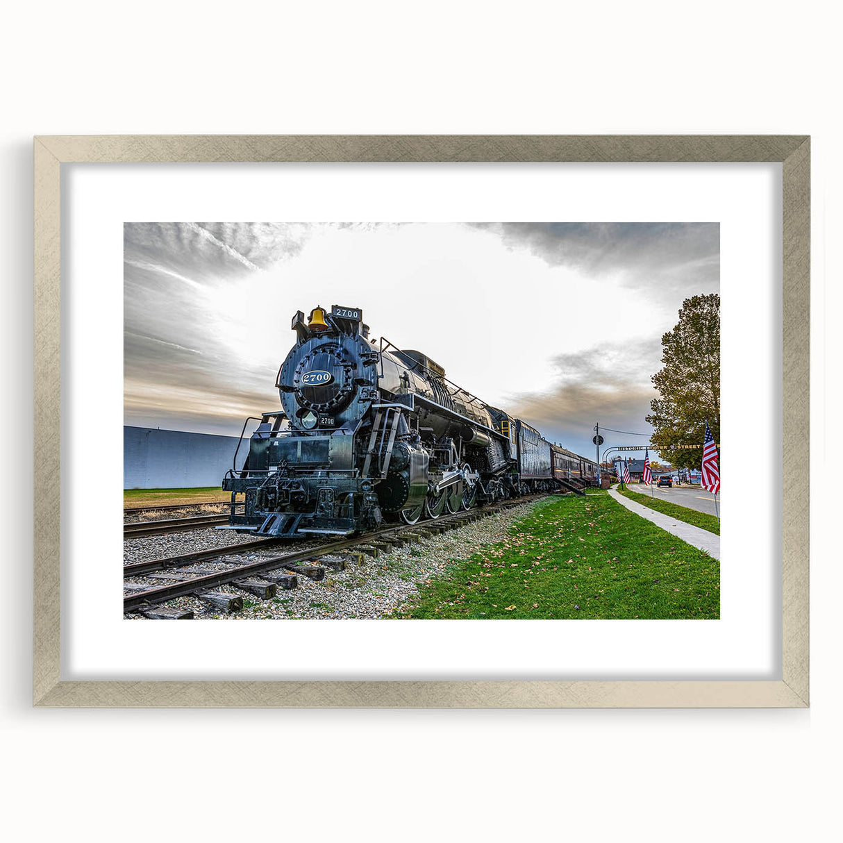 Textured abstract art print of a stylized train in shades of gray and black on a framed canvas, suitable for bedroom decor.