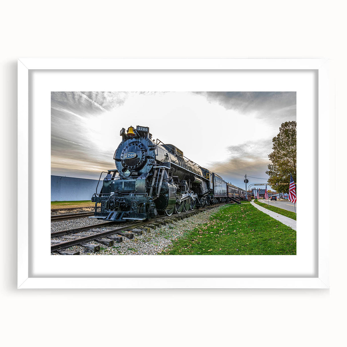 Abstract art print of a stylized train in black and white tones on a white framed canvas, ideal for dining room decor.