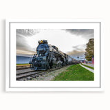 Abstract art print of a stylized train in black and white tones on a white framed canvas, ideal for dining room decor.
