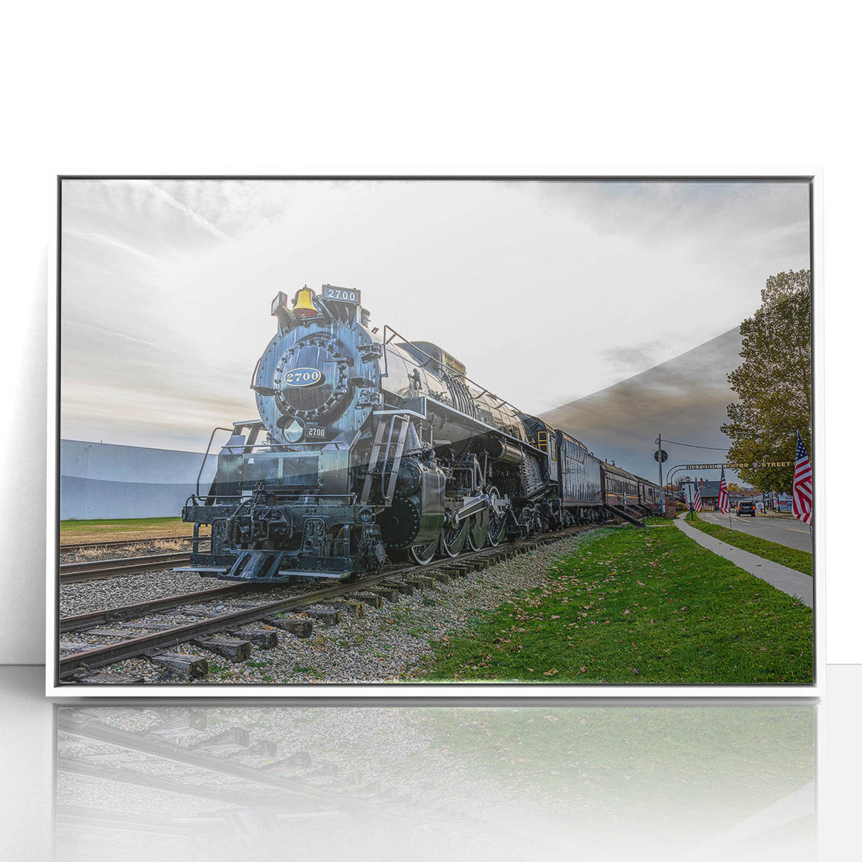 Art deco style train illustration in muted gray and blue tones on a white acrylic framed poster.