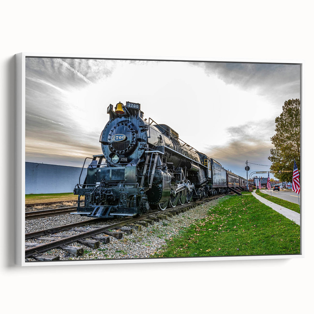 Vintage poster art of a classic train in colorful detail on a large framed canvas, ideal for living room decor.