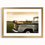 Extra large abstract art print of colorful trucks on a textured canvas, framed in gold, ideal for living room decor.