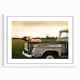 Abstract art print of colorful trucks on a white framed poster, ideal for dining room decor.