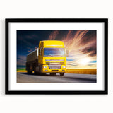 Abstract art print of colorful, textured trucks on a large canvas, framed in black, suited for living room decor.