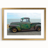 Abstract art print of textured trucks in muted earth tones on a large framed canvas, ideal for living room decor.