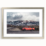 Abstract art print of trucks in textured style with muted earth tones on a silver-framed mat, suitable for bedroom art.