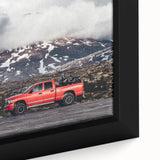 Close-up of a black framed canvas featuring colorful, textured trucks, ideal for extra large living room wall art.