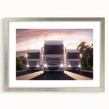 Textured art print of abstract trucks in gray and silver tones, framed with a silver mat, suitable for bedroom decor.