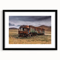 Abstract art print of colorful trucks, textured design on a large canvas, framed in black, ideal for living room decor.