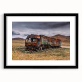 Abstract art print of colorful trucks, textured design on a large canvas, framed in black, ideal for living room decor.