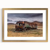 Extra large abstract art print featuring textured trucks in muted browns and grays, framed in gold.