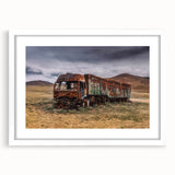 Abstract art print of colorful trucks on white framed canvas, suited for dining room or bedroom decor.